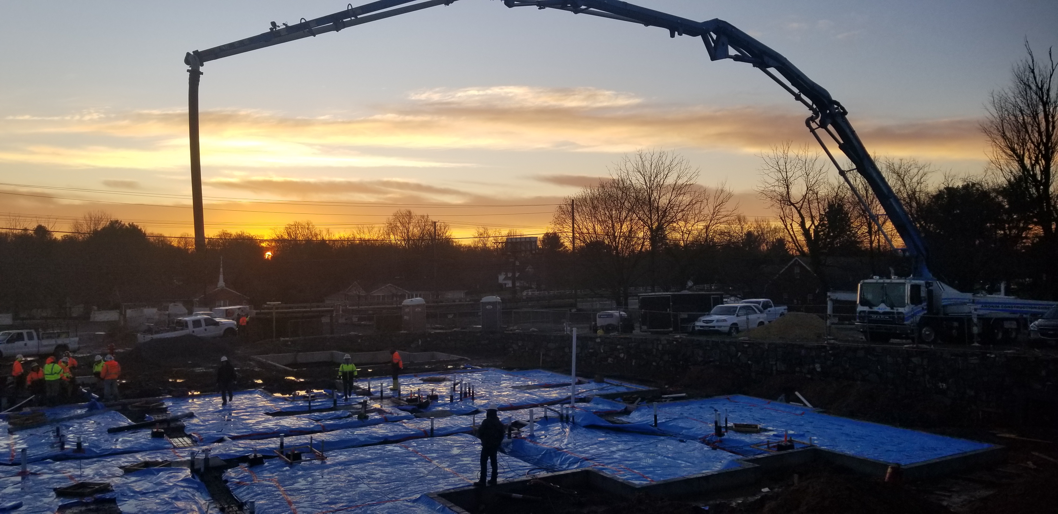 Large scale commercial foundation concrete pour at sunrise